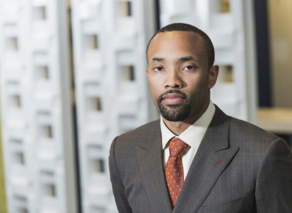Young black businessman in office looking at camera